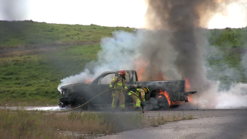 firefighters douse burning pickup truck