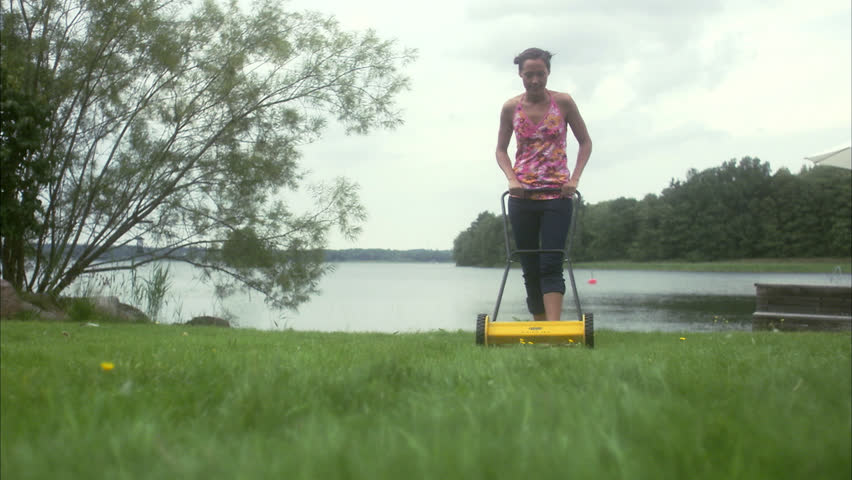 A woman using a lawn mower