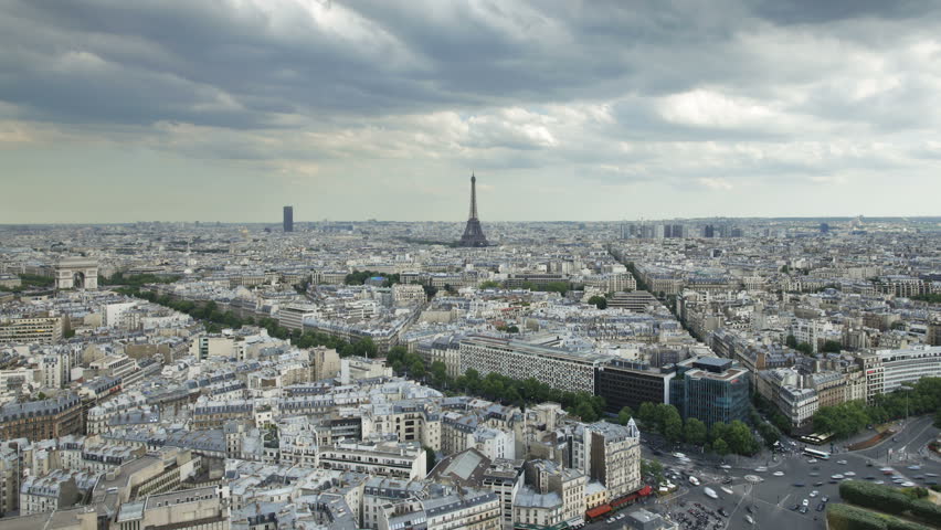 Aerial view of the City of Paris with the Eiffel Tower in the distance on a cloudy day