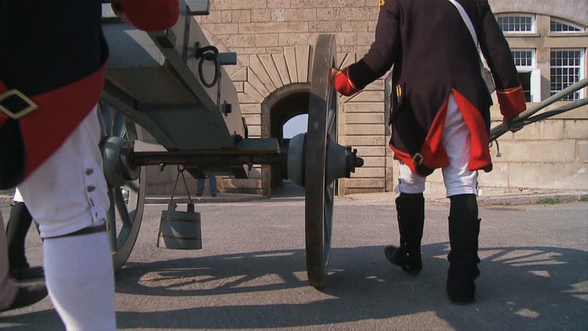 NEWPORT, RHODE ISLAND - CIRCA SEPTEMBER 2007: Revolutionary War reenactment soldiers rolling a canon through fort entrance