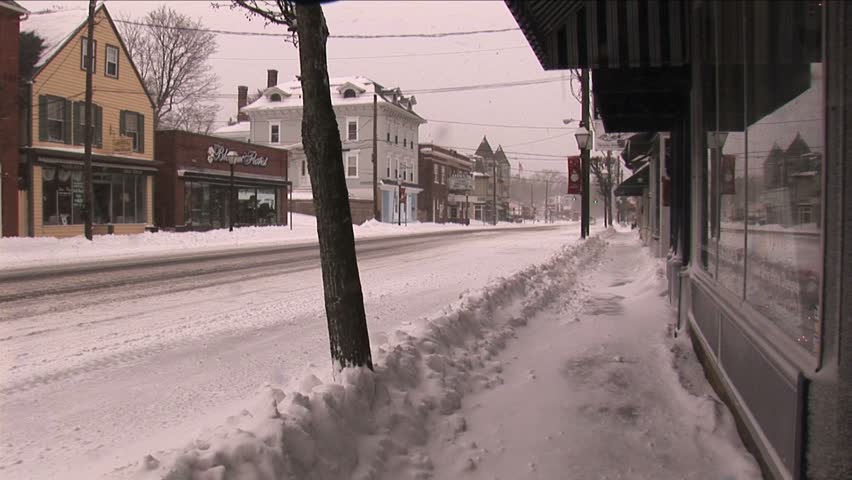 NEW ENGLAND - CIRCA JANUARY 2006: Small downtown retail storefronts and street in snow