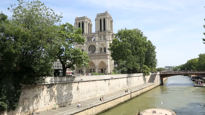 Bateau-mouche cruising by Notre Dame of Paris cathedral