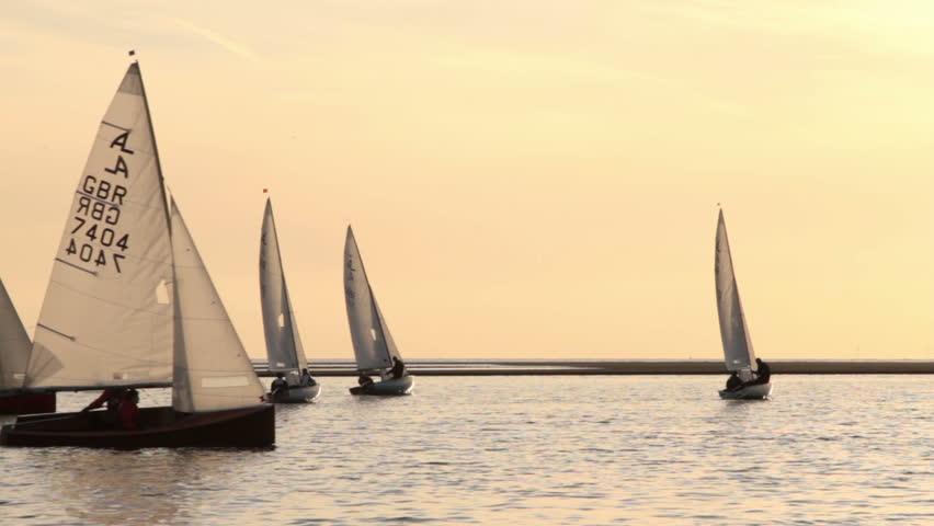 WIRRAL, CHESHIRE/ENGLAND - MAY 16: Unidentified sail boat and crew gybe on the Marine Lake  on May 16, 2012 in West Kirby. The Marine Lake is a man made coastal lake fed by the sea at high tide.