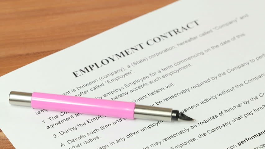 Woman signing an employment contract with a fountain pen