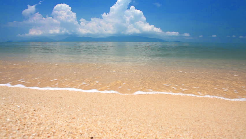 waves landing on sandy beach