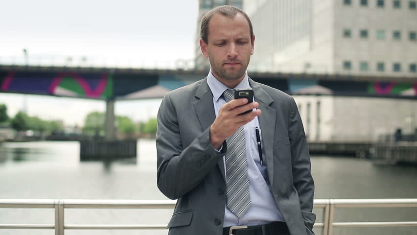Young handsome businessman with smartphone in the city
