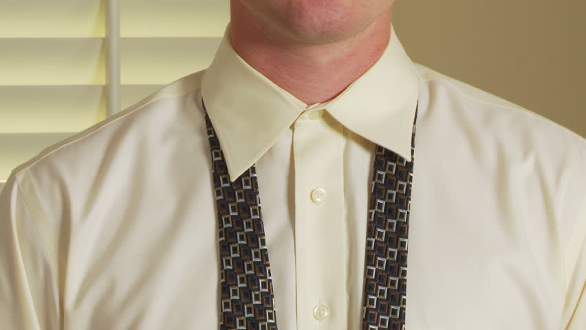 Close up of man tying tie