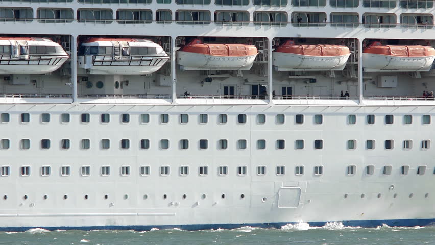 Cruise ship leaving Lisbon harbor, still with the river pilots boat attached. Close up.