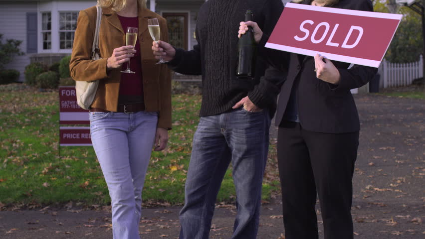 MS, TU, Couple holding champagne glasses, real estate agent holding SOLD sign