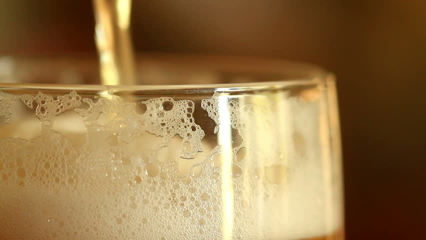 Pouring beer into a glass. close up.
