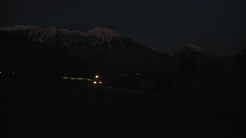 SWISS ALPS, SWITZERLAND-CIRCA 2011-A train passes in the dead of night.