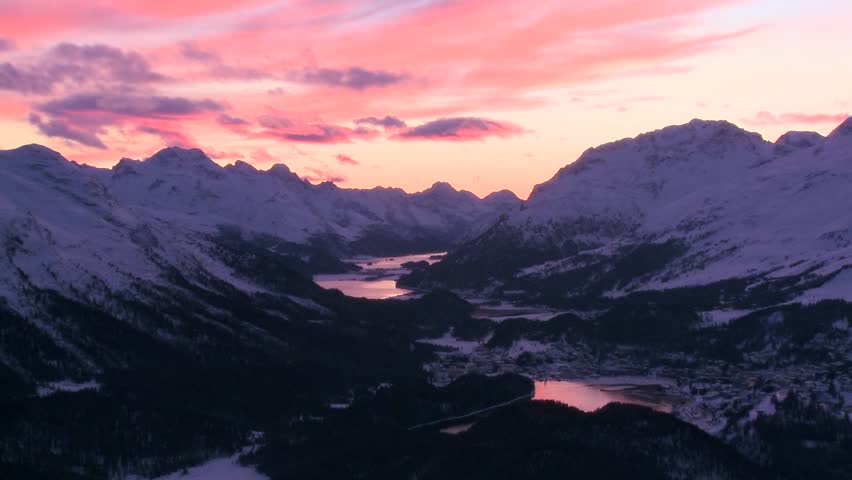 ST. MORITZ, SWITZERLAND-CIRCA 2011-Beautiful time lapse shot of sunset behind a mountain town.