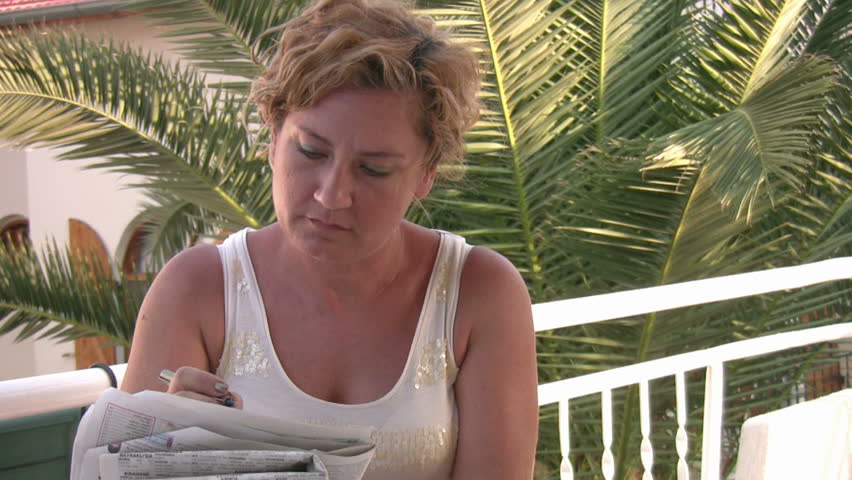 Woman solving crossword puzzle