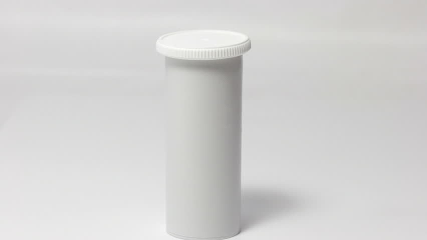 Hand picks a white vial