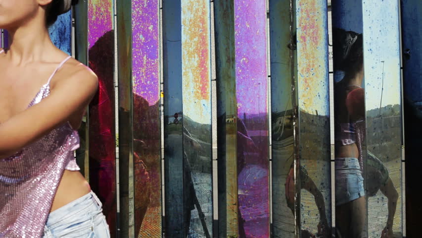 a sexy gogo dancer shot against a unique coloured chrome metal background