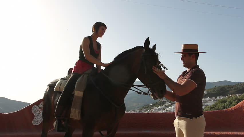 Man chatting to a woman on horseback in Andalusia, Spain