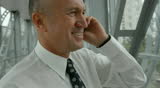 senior businessman standing and talking on cellphone in transit station overpass. camera stabilizer shot. 