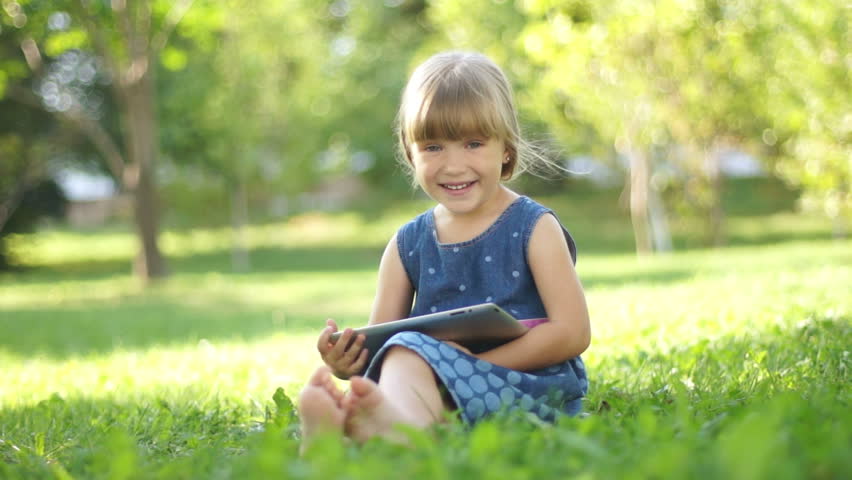 Girl online with tablet pc outdoors. Thumbs up. Ok
