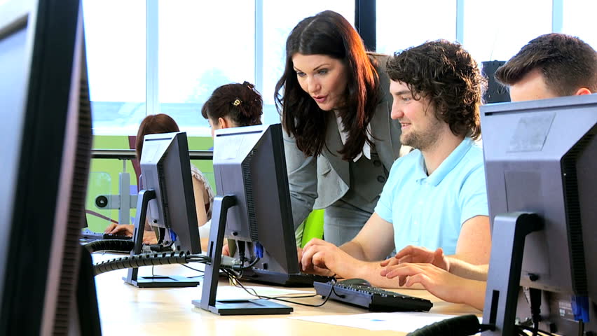 Caucasian and Indian classmates learning with university female lecturer in modern technology class