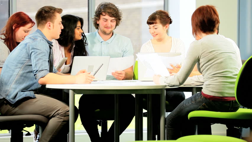 Friendly young multi ethnic graduate classmates degree with technical support in modern university