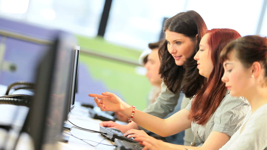 Group of multi ethnic male and female students focus on project instruction Caucasian female lecturer in IT information library