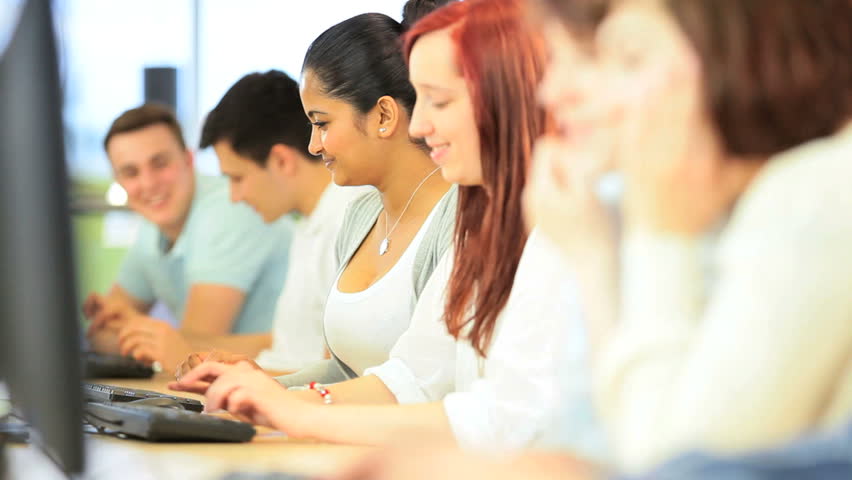 Portrait of smiling Indian female classmate e-learning with university friends in modern classroom