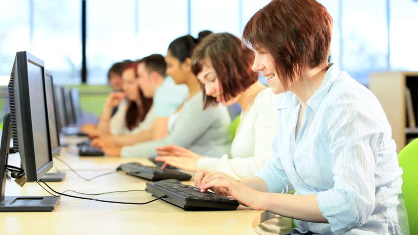 Multi ethnic happy student friends e-learning networking in college IT library