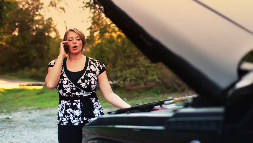 A stranded woman is frustrated by her disabled vehicle.
