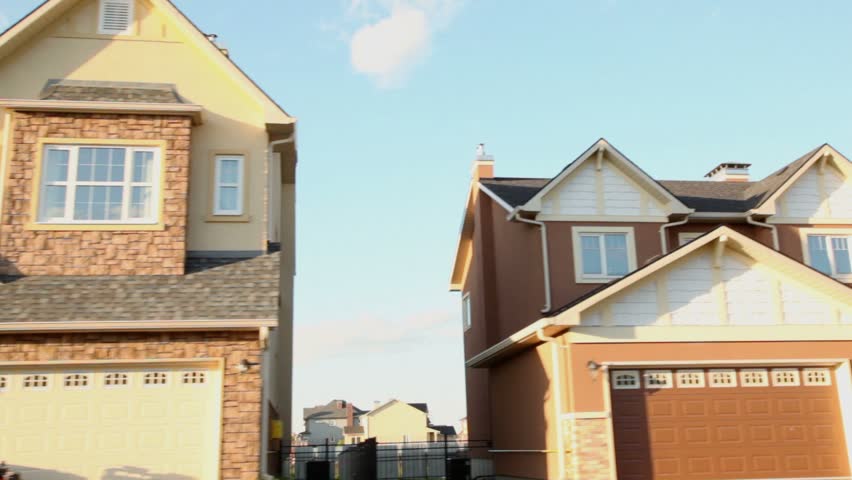 Suburban neighborhood. Lot of cottages in village on sunny summer day, carview with motion. pov shot.