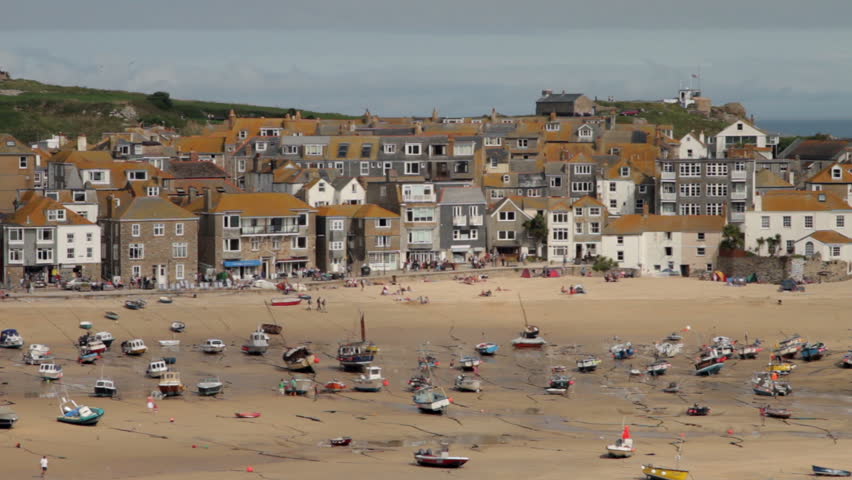 ST IVES, CORNWALL/ENGLAND - SEPTEMBER 3: Fishing and tourist boats lie on the sand at low tide on September 3, 2012 in St Ives. St Ives is a major seaside tourist destination.