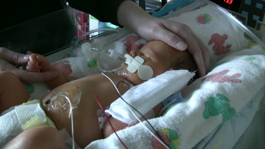 Neonatal unit with premature baby getting touched by mom.  HD 1080i