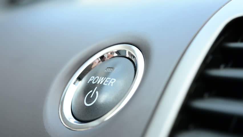 Pushing a power button in modern hybrid car