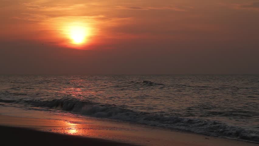 Loop features a beautiful sunrise sky above a sandy beach with crashing waves.