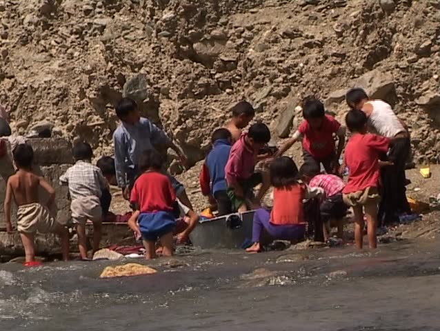 Child labor - laundering in the mountain river