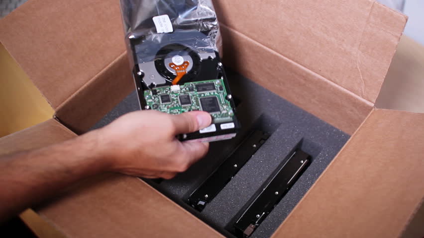 A technician prepares a shipment of hard drives.
