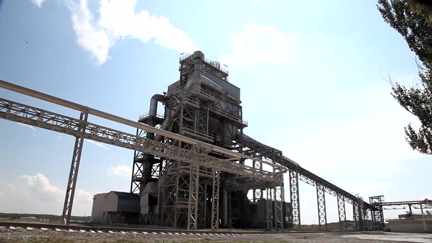 Cement factory machinery on a clear blue day