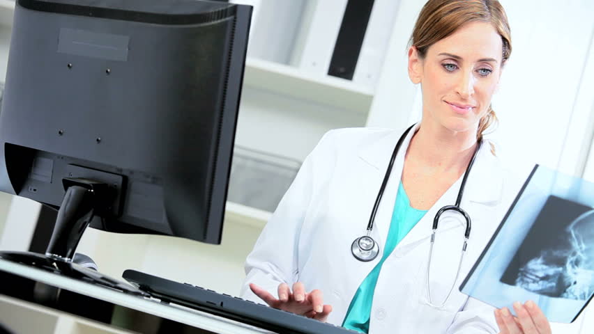 Caucasian hospital doctor checking patient x-ray results