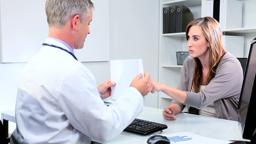 Pharmaceutical company representative and senior doctor discussing future orders office