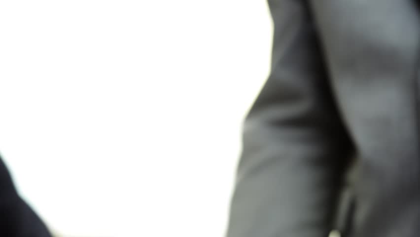 Business Handshake two businessman shaking hands closeup motion track high definition