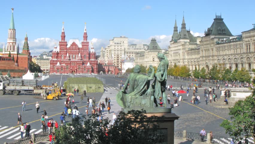 Tourists walk across Red Square near GUM in sunny day, time lapse