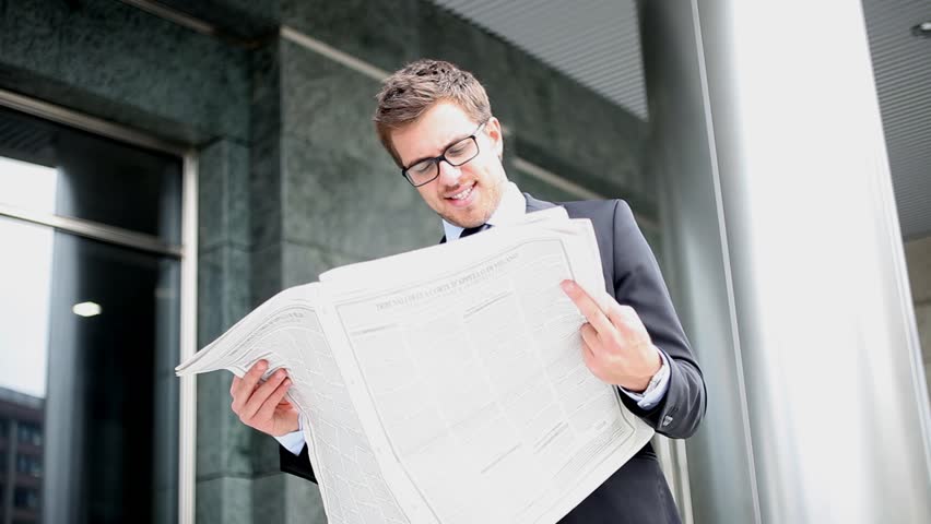 Businessman reading a newspaper outdoor
