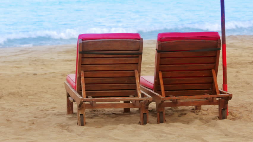 two sunbeds on beach