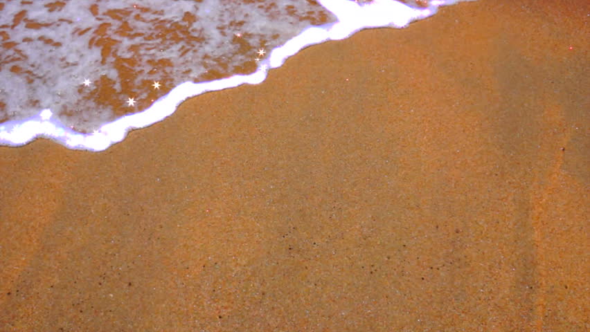 Wave Foam With Sparkle
Foamy waves with sparkles roll over the sandy textural beach.