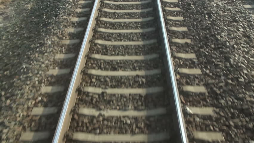 train passing through countryside, moving railroad tracks