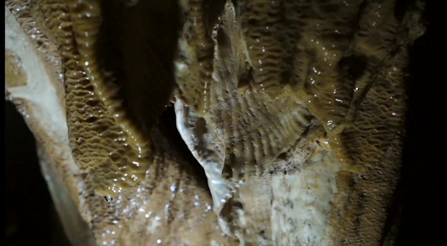 Water drip from stalactites and stalagmites inside the cave