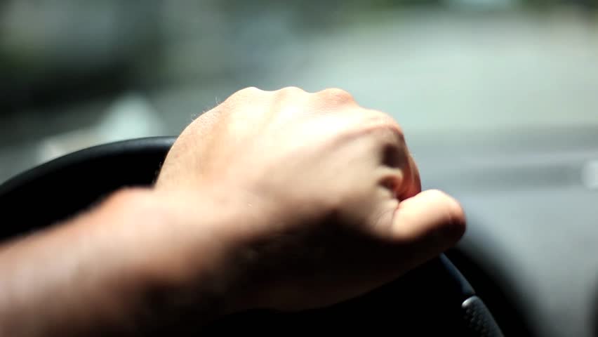 Hand on steering wheel