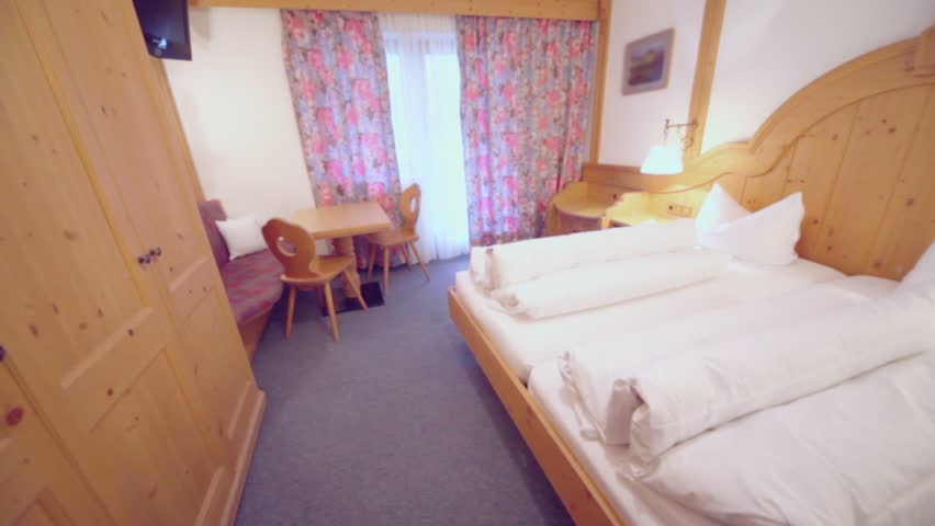 Hotel bedroom with beds and other furniture, panoramic motion