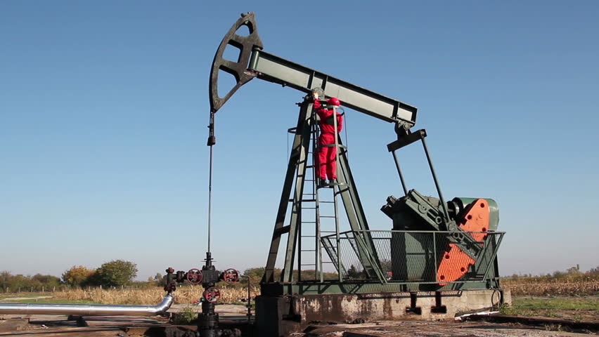 Oil Worker Turning Valve On Oil Rig.
Worker in action at pump jack oil well. HD1080p. 
