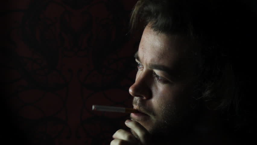 Smoking man against dark background