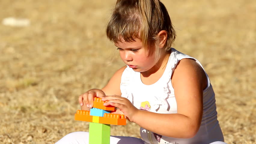 Kid building

Description: Little girl building a house with plastic bricks      
